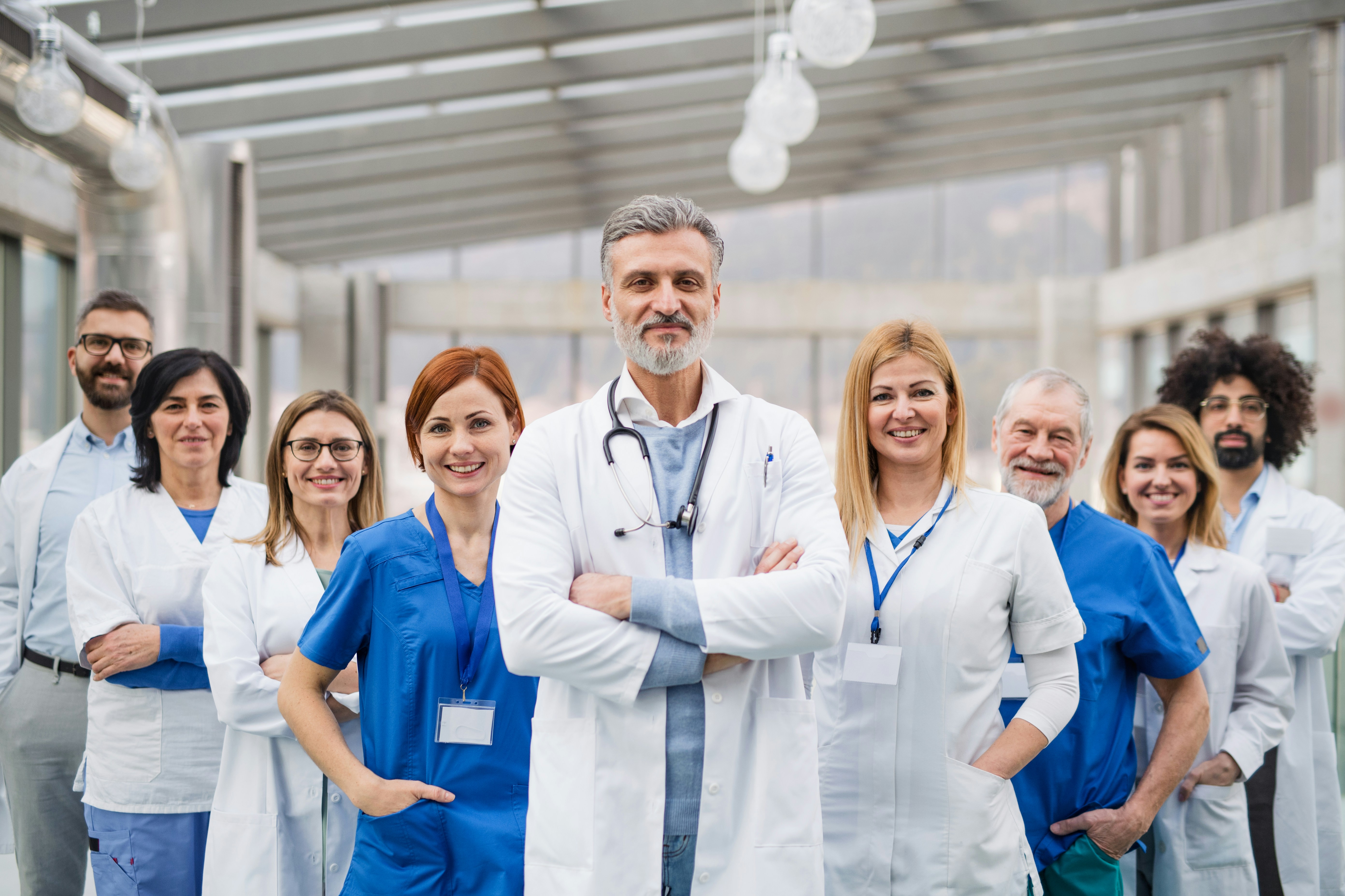 Clinical team standing together in a hospital atrium